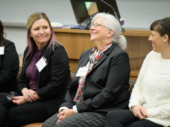 Three women laughing and chatting at the LP Summit