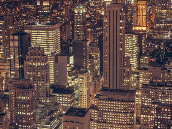 Dense downtown at night packed with skycrapers