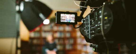 A Sony FS7 camera system filming an interview in an office A Sony FS7 camera system filming an interview in an office