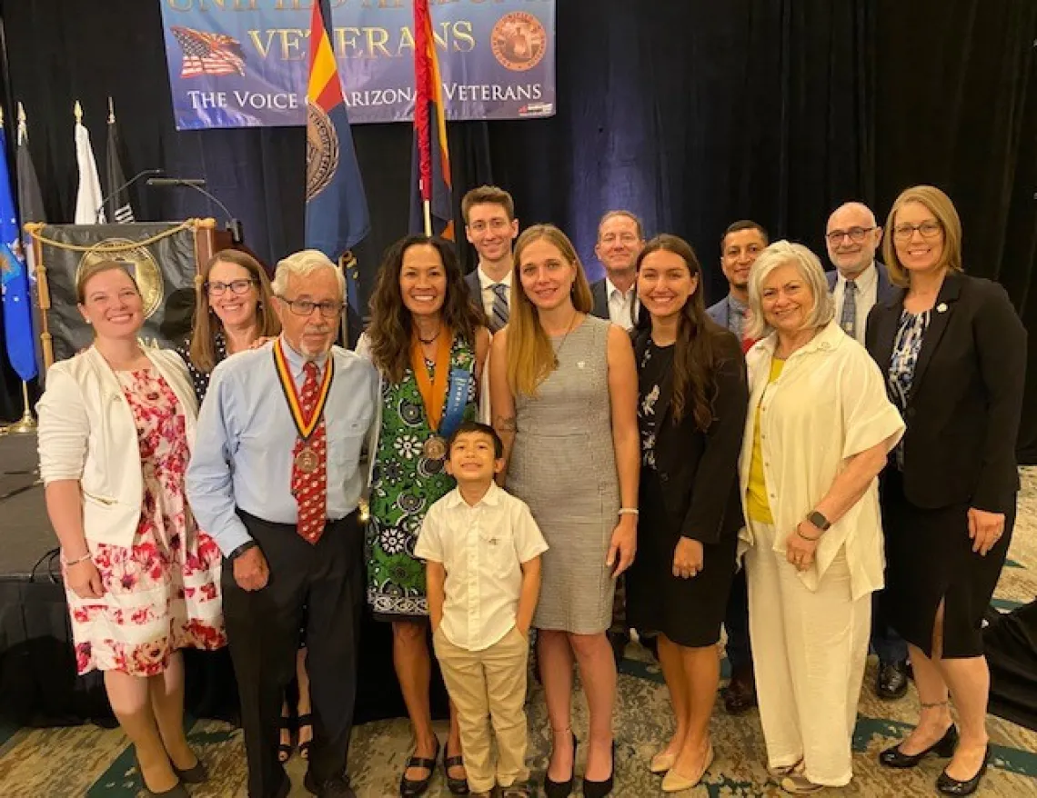 Kristine Huskey surrounded with current and former students, professors and family after receiving award Kristine Huskey surrounded with current and former students, professors and family after receiving award