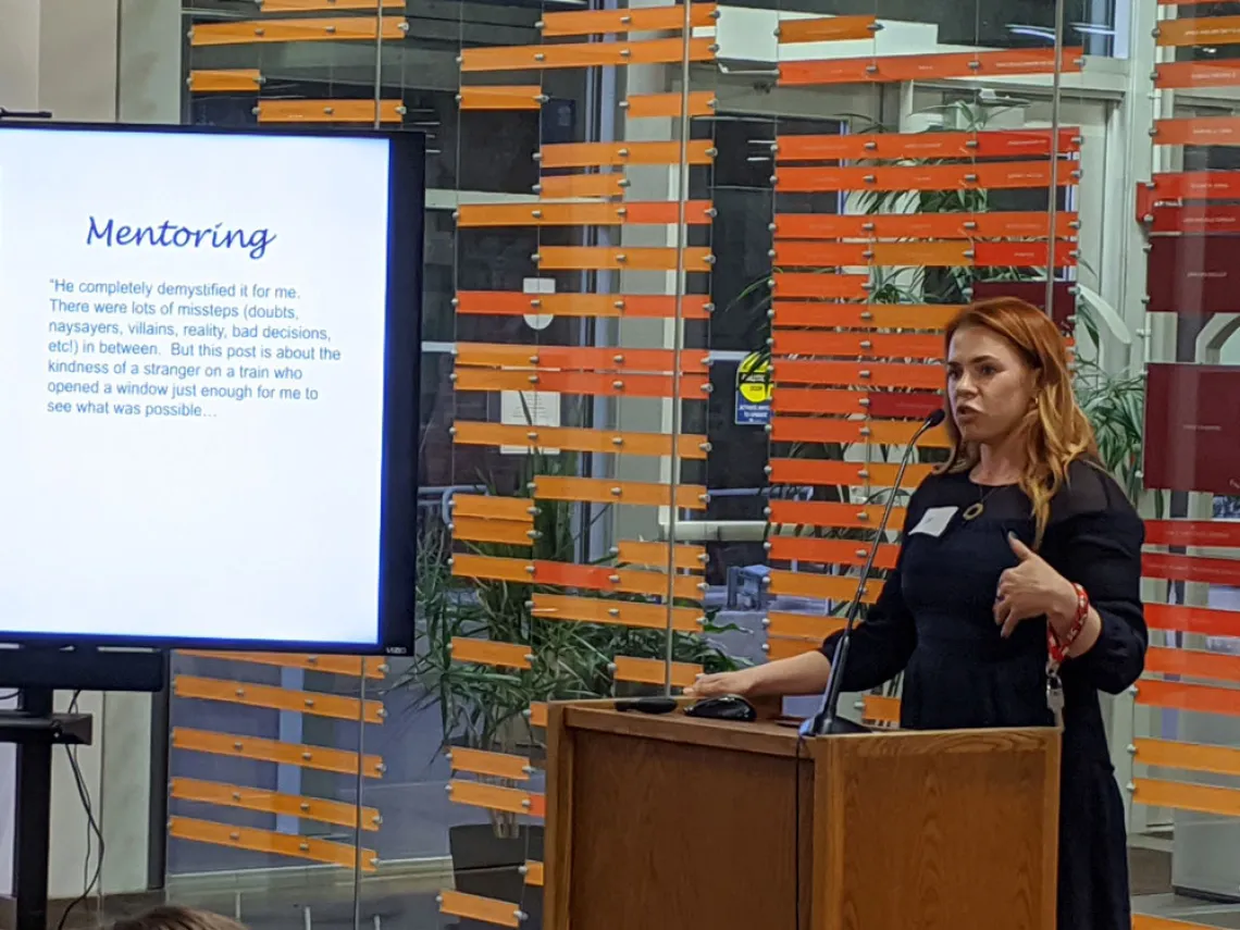 Woman speaking behind a podium